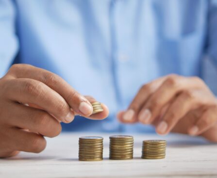 a person stacking coins on top of a table