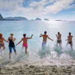 group of people playing on beach