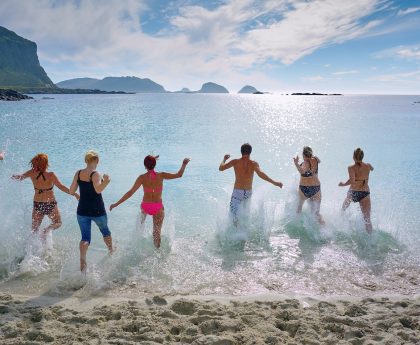 group of people playing on beach