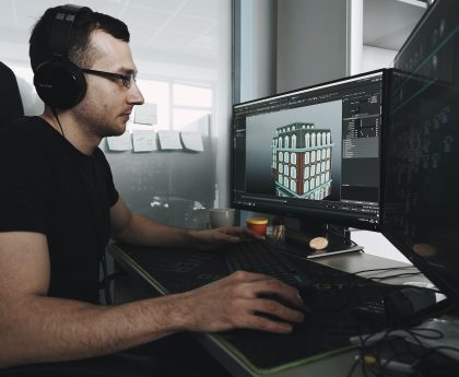 man in black tank top wearing black sunglasses using computer