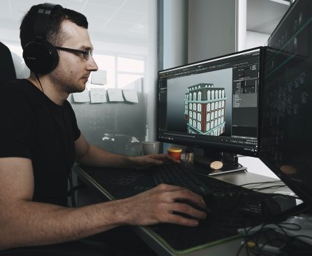 man in black tank top wearing black sunglasses using computer