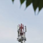 a red and white tower with a leaf on top