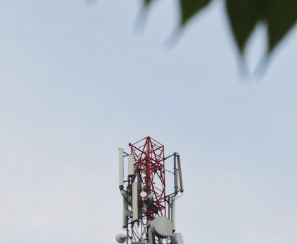 a red and white tower with a leaf on top