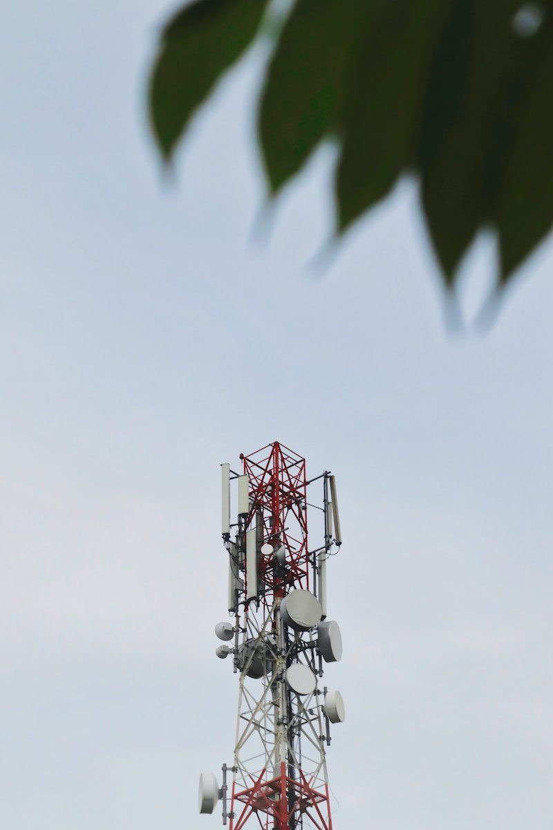 a red and white tower with a leaf on top